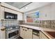 Bright kitchen with stainless steel appliances and charming tile backsplash at 3906 Versailles Dr, Tampa, FL 33634