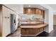 View of kitchen with tiled backsplash, light cabinets, stainless steel refrigerator, and bar top counter space at 3906 Versailles Dr, Tampa, FL 33634