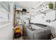 Compact laundry area with modern washer and dryer and organized storage at 3906 Versailles Dr, Tampa, FL 33634