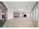 Spacious living room with tile flooring, a fireplace, skylights and sliding glass doors at 3906 Versailles Dr, Tampa, FL 33634