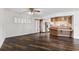 Open-concept living room featuring dark wood floors and a ceiling fan at 3906 Versailles Dr, Tampa, FL 33634