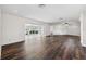 Open-concept living area with hardwood floors and lots of natural light from large windows at 3906 Versailles Dr, Tampa, FL 33634