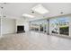 Spacious room features tile flooring, a fireplace, and sliding glass doors with views of the waterfront at 3906 Versailles Dr, Tampa, FL 33634