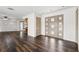 Living area with wood floors, light colored walls, wooden door and kitchen entryway at 3906 Versailles Dr, Tampa, FL 33634