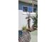 Inviting outdoor shower area featuring a wooden platform, river rock detail, and lush tropical foliage at 3906 Versailles Dr, Tampa, FL 33634