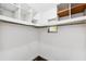 Walk-in closet with a window, hanging rod, and white shelving for optimal storage at 3906 Versailles Dr, Tampa, FL 33634