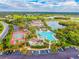 Aerial view of community clubhouse, pool, tennis courts, lake and landscaping at 411 Bloom Ct # 2A, Sun City Center, FL 33573