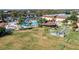 An aerial view of community pool and green lawns with several recreational activities taking place at 411 Bloom Ct # 2A, Sun City Center, FL 33573