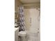 Bathroom with a shower and tub combination, featuring a decorative shower curtain and tiled walls at 411 Bloom Ct # 2A, Sun City Center, FL 33573