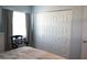 Bedroom featuring a closet with paneled doors, window, and chair near the bed at 411 Bloom Ct # 2A, Sun City Center, FL 33573