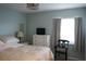 Bedroom featuring a comfortable bed, dresser, and a chair near the bright window at 411 Bloom Ct # 2A, Sun City Center, FL 33573