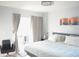 Bedroom featuring bright window, bed and a gray chair near the window at 411 Bloom Ct # 2A, Sun City Center, FL 33573