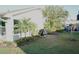 View of home with lush landscaping and manicured lawn creating a tranquil outdoor living space at 411 Bloom Ct # 2A, Sun City Center, FL 33573