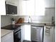 Well-equipped kitchen with stainless steel appliances and sleek white cabinets at 411 Bloom Ct # 2A, Sun City Center, FL 33573
