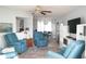 Cozy living room with comfortable blue armchairs and a view into the dining area at 411 Bloom Ct # 2A, Sun City Center, FL 33573