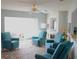 Inviting living room with a ceiling fan, three armchairs and bright, open space at 411 Bloom Ct # 2A, Sun City Center, FL 33573