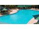 Outdoor pool with lounge chairs and umbrellas to enjoy on a sunny day at 411 Bloom Ct # 2A, Sun City Center, FL 33573