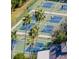 An aerial view shows the tennis courts with people playing tennis at 411 Bloom Ct # 2A, Sun City Center, FL 33573