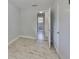 Bedroom featuring wood-look tile flooring, closet and view into the bathroom at 434 Pevetty Dr, Plant City, FL 33563