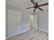 Bedroom featuring wood-look tile flooring, ceiling fan and closet and bathroom access at 434 Pevetty Dr, Plant City, FL 33563