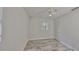Neutral bedroom with wood-look tile flooring, a window with blinds and a ceiling fan at 434 Pevetty Dr, Plant City, FL 33563