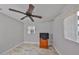 Cozy bedroom with wood-look tile flooring, a window with blinds, a ceiling fan and dresser at 434 Pevetty Dr, Plant City, FL 33563