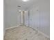 Bedroom featuring wood-look tile flooring, closet and bathroom access at 434 Pevetty Dr, Plant City, FL 33563