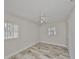 Bright bedroom with wood-look tile flooring, two windows with blinds, a ceiling fan and closet at 434 Pevetty Dr, Plant City, FL 33563