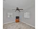 Neutral bedroom with wood-look tile flooring, two windows with blinds, a ceiling fan and dresser at 434 Pevetty Dr, Plant City, FL 33563