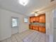 Bright kitchen features wood cabinets, granite countertops, white appliances, and tile flooring at 434 Pevetty Dr, Plant City, FL 33563