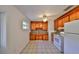 Charming kitchen features wood cabinets, granite countertops, and tile flooring at 434 Pevetty Dr, Plant City, FL 33563