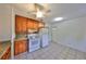 Practical kitchen with wooden cabinets, tile backsplash, modern appliances, and tiled floor at 434 Pevetty Dr, Plant City, FL 33563