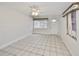 Cozy living room featuring tile floors, bright windows, and open layout perfect for entertaining guests at 434 Pevetty Dr, Plant City, FL 33563