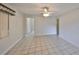 Bright, spacious living room with tile flooring, ceiling fan, and a view to the hallway at 434 Pevetty Dr, Plant City, FL 33563