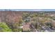 Scenic aerial shot of a backyard featuring a pool surrounded by mature trees at 4932 Wellbrook Dr, New Port Richey, FL 34653