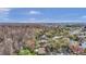 Wide aerial panorama displaying houses nestled among trees with a clear blue sky at 4932 Wellbrook Dr, New Port Richey, FL 34653