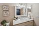 Modern bathroom featuring a marble countertop vanity and decorative wall art at 4932 Wellbrook Dr, New Port Richey, FL 34653