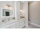 Elegant bathroom with double sinks, modern lighting, white cabinetry, and marble countertops at 4932 Wellbrook Dr, New Port Richey, FL 34653