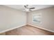 Bright bedroom with a ceiling fan, neutral walls, and wood-look floors at 4932 Wellbrook Dr, New Port Richey, FL 34653