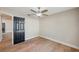 Bright bedroom features wood floors and a black door with a ceiling fan at 4932 Wellbrook Dr, New Port Richey, FL 34653