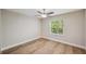 Bright bedroom with wood floors, window and a ceiling fan at 4932 Wellbrook Dr, New Port Richey, FL 34653