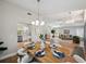 Open dining space connects to the living room, featuring modern lighting and a view into the kitchen at 4932 Wellbrook Dr, New Port Richey, FL 34653