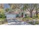 Charming one-story home featuring a vibrant red door and a well-maintained lawn at 4932 Wellbrook Dr, New Port Richey, FL 34653