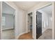 Hallway featuring wood floors and various doorways leading to different rooms at 4932 Wellbrook Dr, New Port Richey, FL 34653
