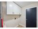 Bright laundry room with overhead cabinets and neutral-colored walls at 4932 Wellbrook Dr, New Port Richey, FL 34653