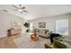 Bright living room featuring modern furnishings, wood floors, neutral walls, and plenty of natural light at 4932 Wellbrook Dr, New Port Richey, FL 34653