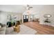 Living room boasts lots of light, wood floors, neutral walls, and access to the dining area at 4932 Wellbrook Dr, New Port Richey, FL 34653