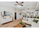 Bright living room featuring hardwood floors, neutral color palette, and access to kitchen at 4932 Wellbrook Dr, New Port Richey, FL 34653