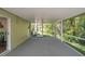 Cozy screened-in porch overlooking the greenery in the backyard at 4932 Wellbrook Dr, New Port Richey, FL 34653