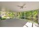 Spacious screened porch with ceiling fans and views of the private backyard at 4932 Wellbrook Dr, New Port Richey, FL 34653